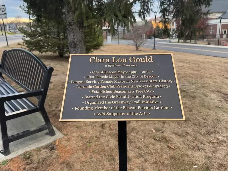  A plaque and bench in front of Municipal Plaza, dedicated to former Mayor, Clara Lou Gould. 