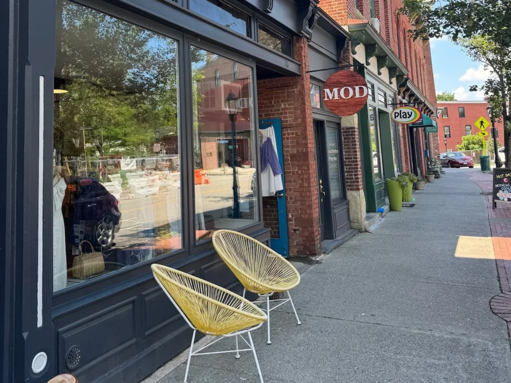 A vintage store called MOD Hudson Valley on a Main Street with two yellow chairs outside.