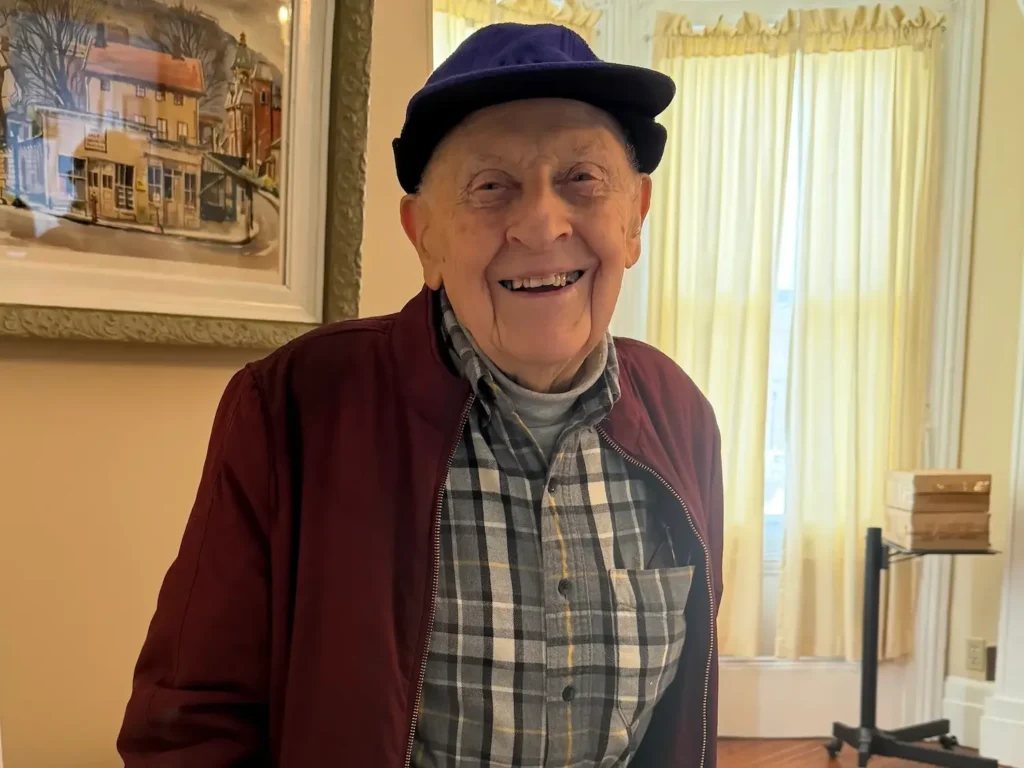 A friendly senior man smiles at the camera