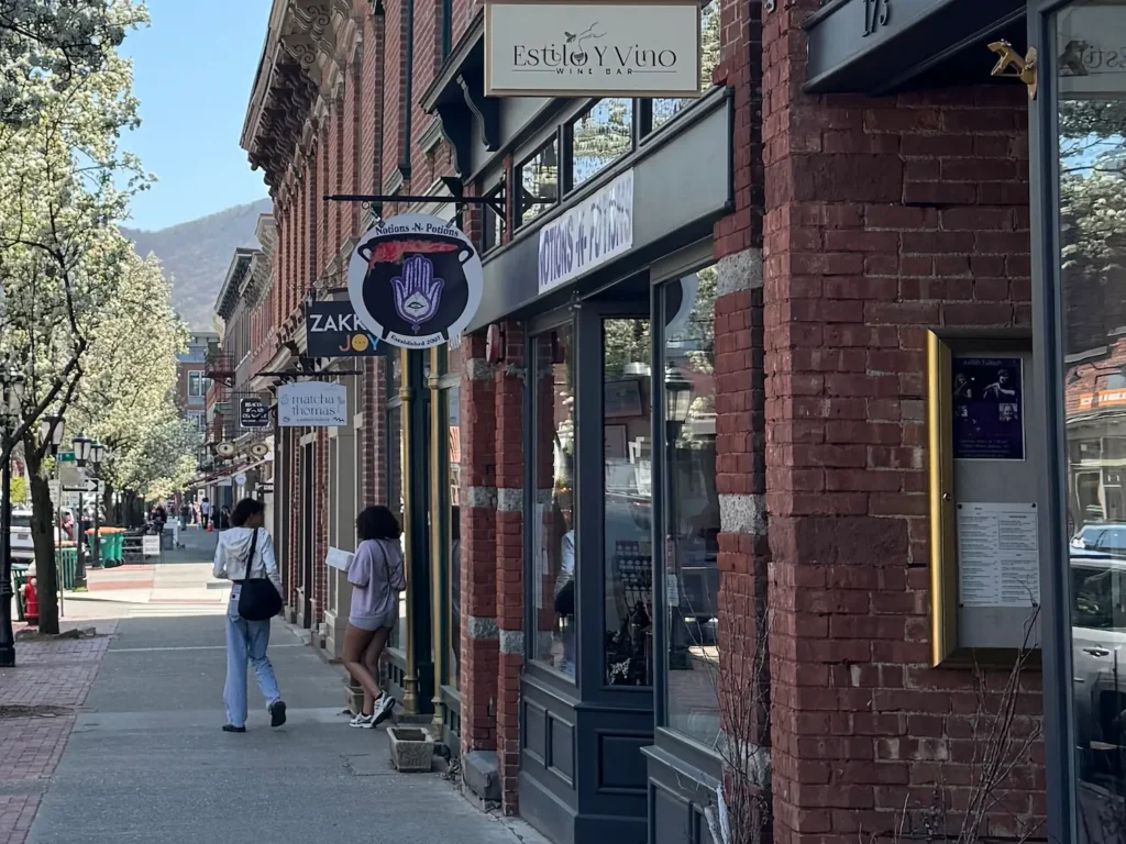 Main Street Beacon in spring with people walking on the sidewalk