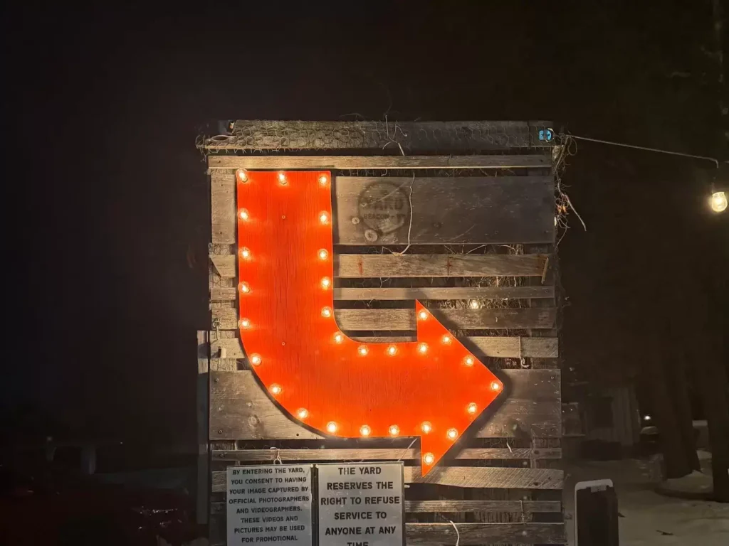 large illuminated red arrow points towards The Yard events venue