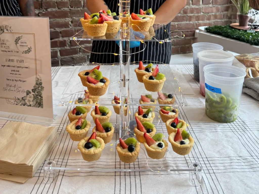 Sweet pastries filled with fruit and cream are displayed on a cake stand.