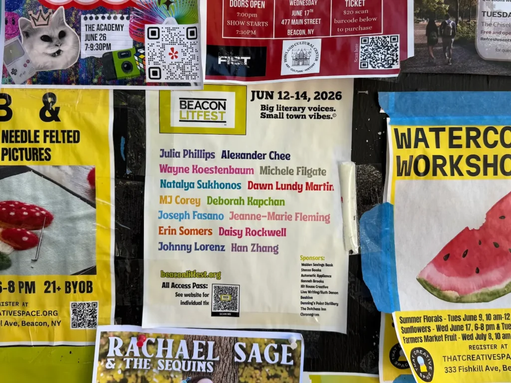 A wall full of colorful posters with one for Beacon Litfest in the center, revealing the names of the authors taking part.